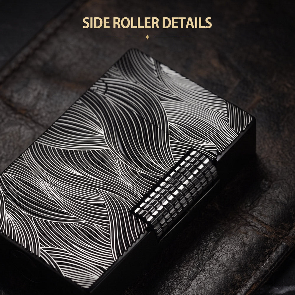 A front-facing shot of the Aqua Rhythm black lighter, featuring striking silver wave engravings against a dark chrome finish with a textured mechanical roller.