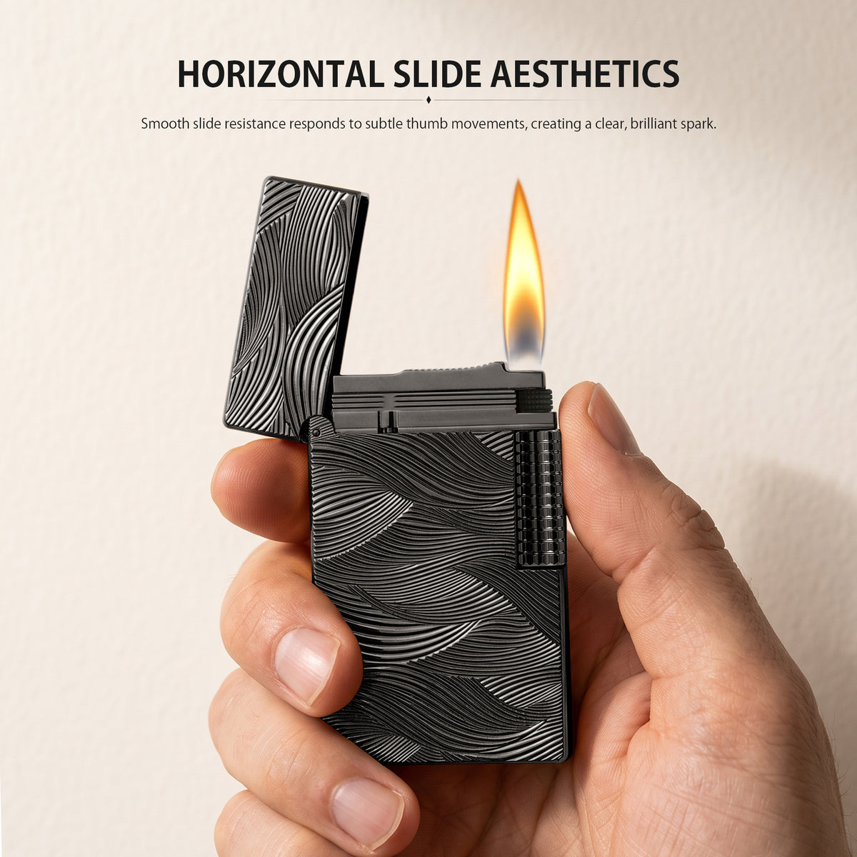 A black Aqua Rhythm lighter with an open lid is ignited, showing a steady flame and spark, featuring a dark brass body with silver wave engravings.