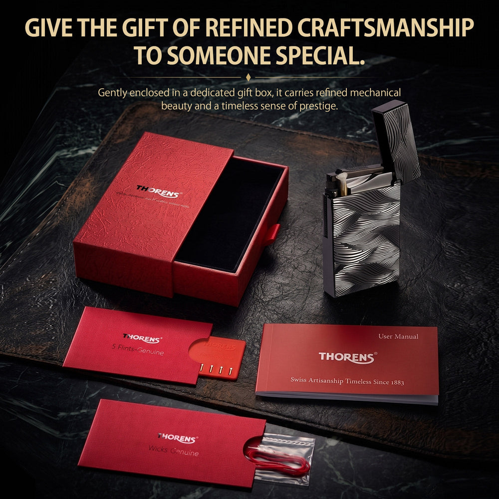 A complete Thorens Aqua Rhythm black lighter set including the signature red gift box, replacement flints, spare wicks, and a user manual.