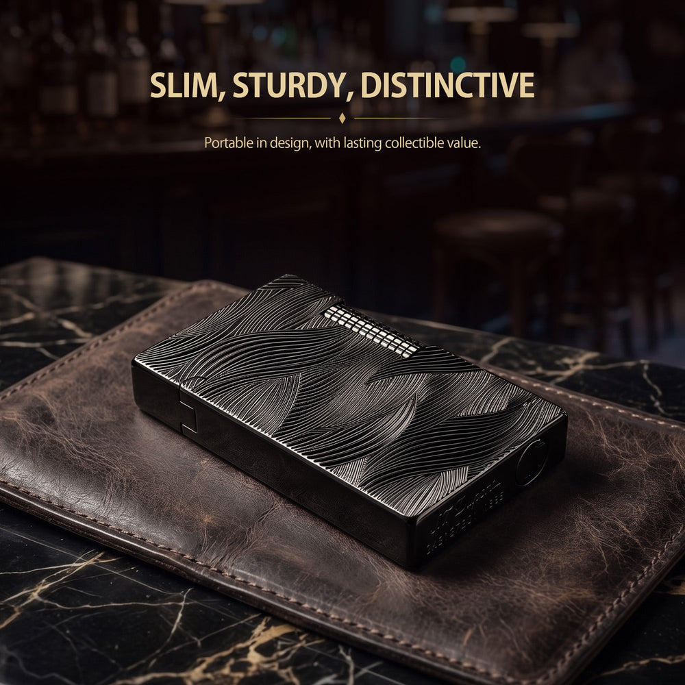 A Thorens Aqua Rhythm black lighter featuring high-contrast silver wave engravings, resting on a textured dark leather surface to highlight its refined EDC aesthetic.