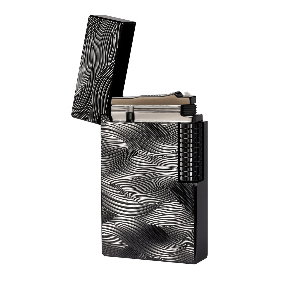 Thorens Aqua Rhythm black lighter with an open cap, showcasing the brass body and intricate silver wave-like engravings with a mechanical side roller.