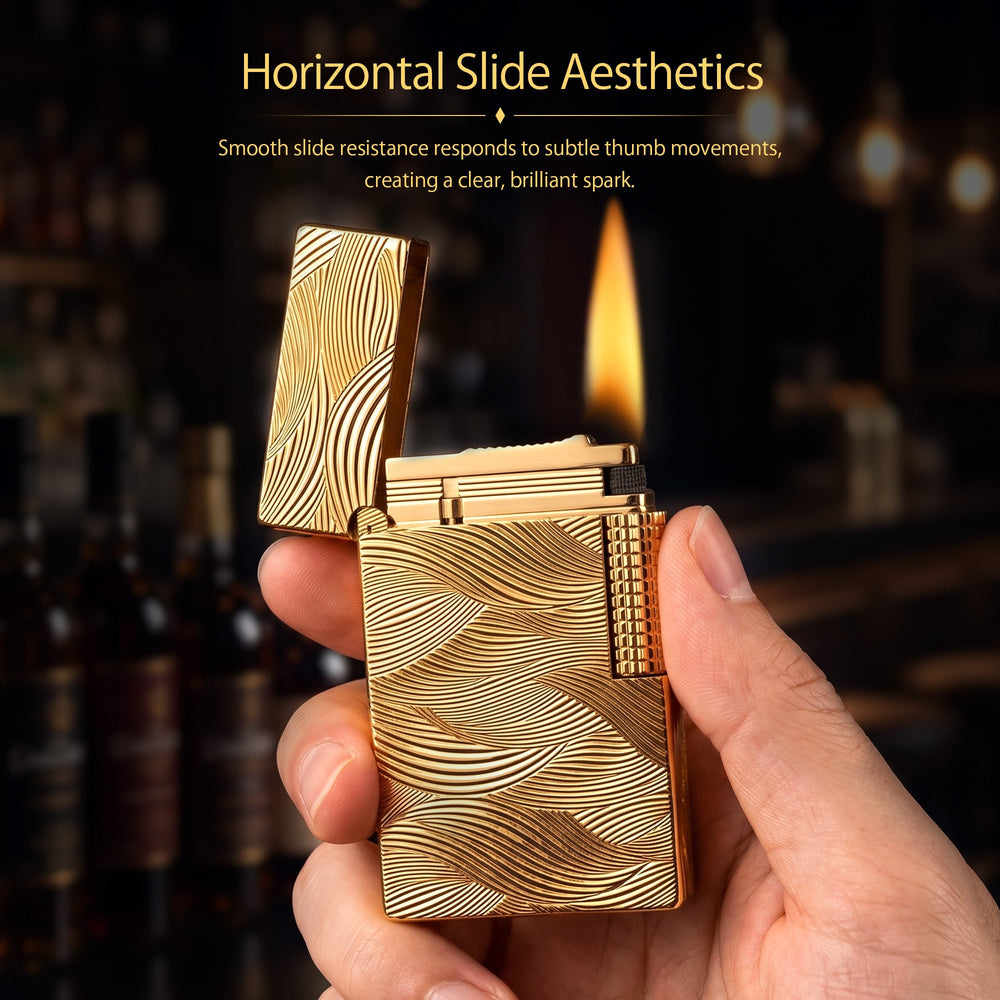 Thorens Aqua Rhythm gold lighter with an open cap, showcasing the brass body and intricate wave-like engravings with a mechanical side roller.