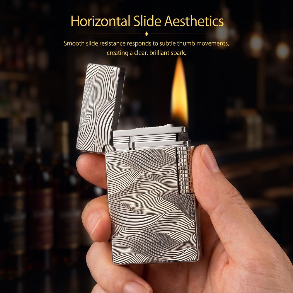 A silver Aqua Rhythm lighter with its lid flipped open, showcasing the contrasting internal mechanism, side roller, and elaborate wave engravings.