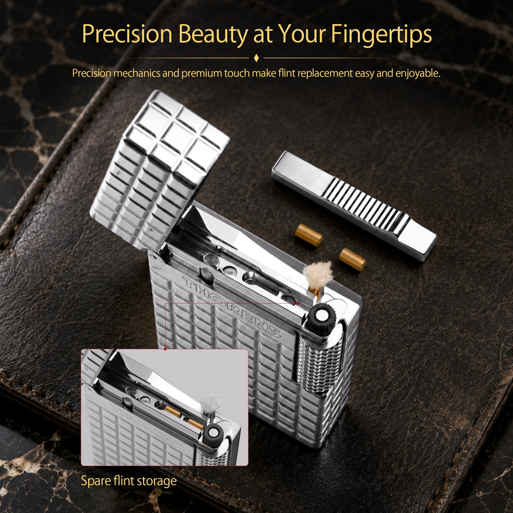A silver Aqua Rhythm lighter with an open lid, ignited to show a steady flame and spark, featuring a classic chrome body with wave engravings.