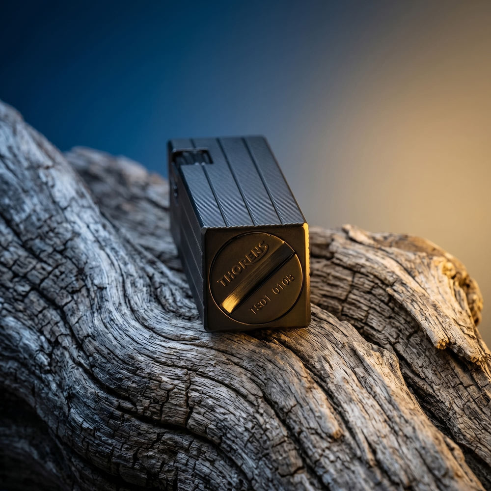 Thorens rectangular lighter with black diagonal pattern shown with the lid down, highlighting the engraved base logo, serial number, and textured surface pattern.