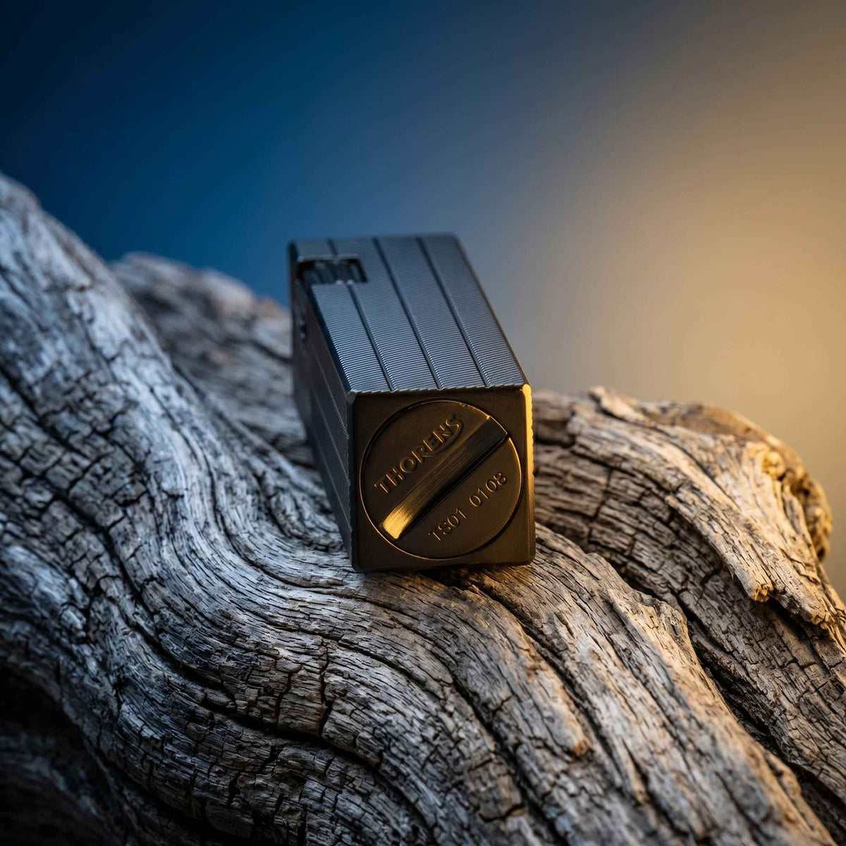 Thorens rectangular lighter with black diagonal pattern shown with the lid down, highlighting the engraved base logo, serial number, and textured surface pattern.