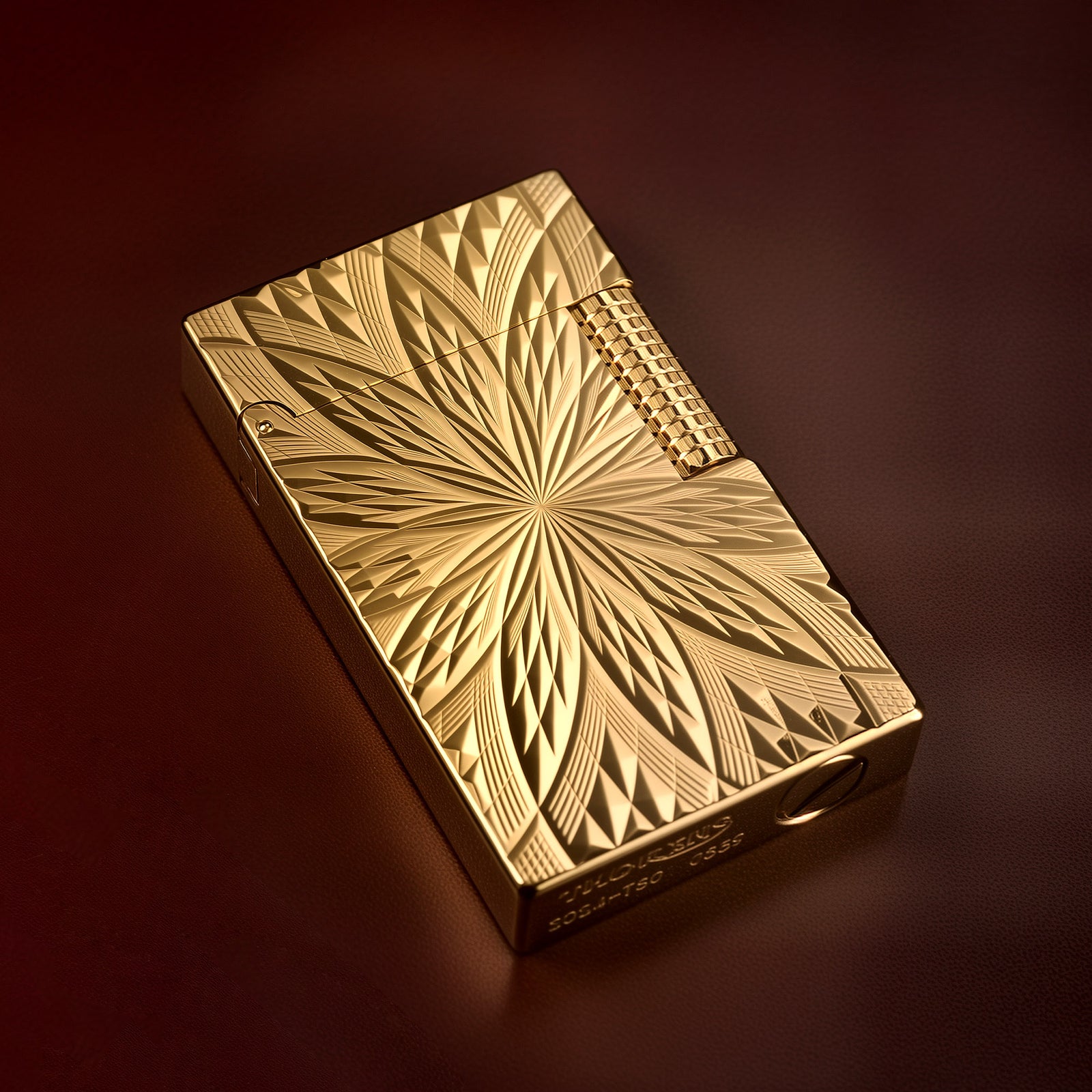 A front-facing showcase of the Thorens Blooming Radiance gold lighter, featuring a brilliant 18k gold-plated finish with intricate symmetrical floral engravings and a textured side roller.