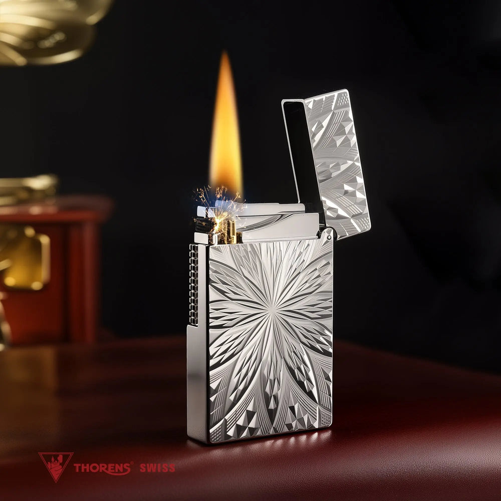 An ignited Blooming Radiance silver-plated lighter with an open lid, showcasing a bright flame and mechanical sparks against the polished, floral-engraved silver body.