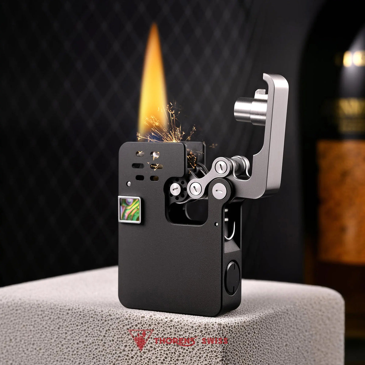A black mechanical ejection lighter with a hollowing machine design, showing the open silver arm mechanism, sparks, and a steady flame.