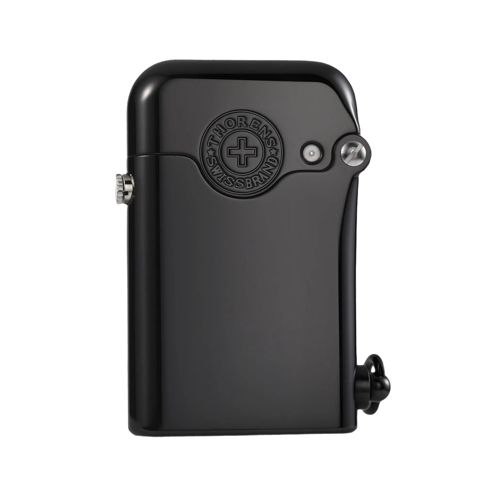 A glossy black Gen 1 Single Claw lighter featuring a raised Thorens Swiss Brand emblem and mechanical side-ignition on a polished brass body.