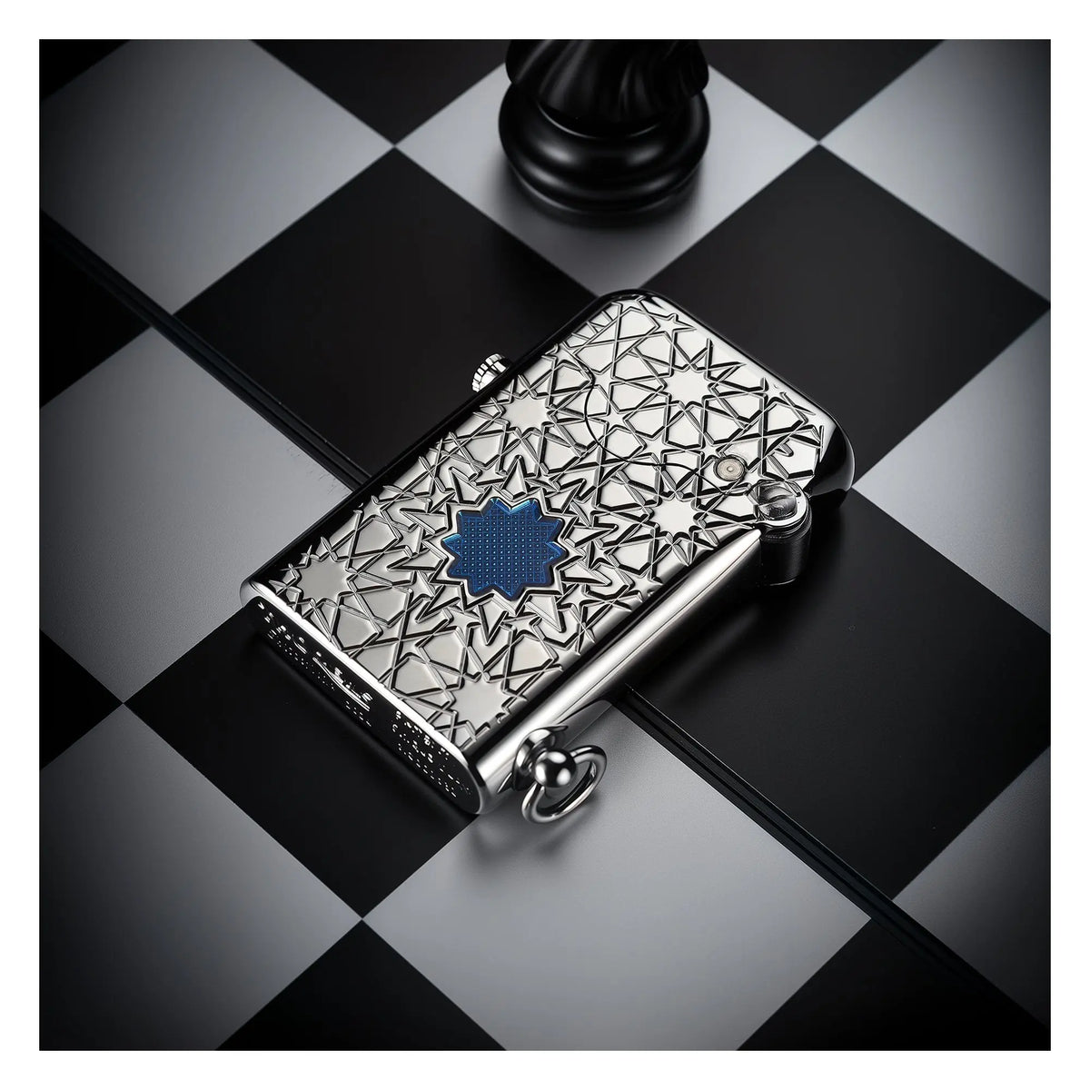 A Thorens Gen 1 Single Claw lighter featuring a silver star engraving and blue lucky star inlay, displayed on a monochrome chessboard to highlight its collectible appeal and refined EDC aesthetics.