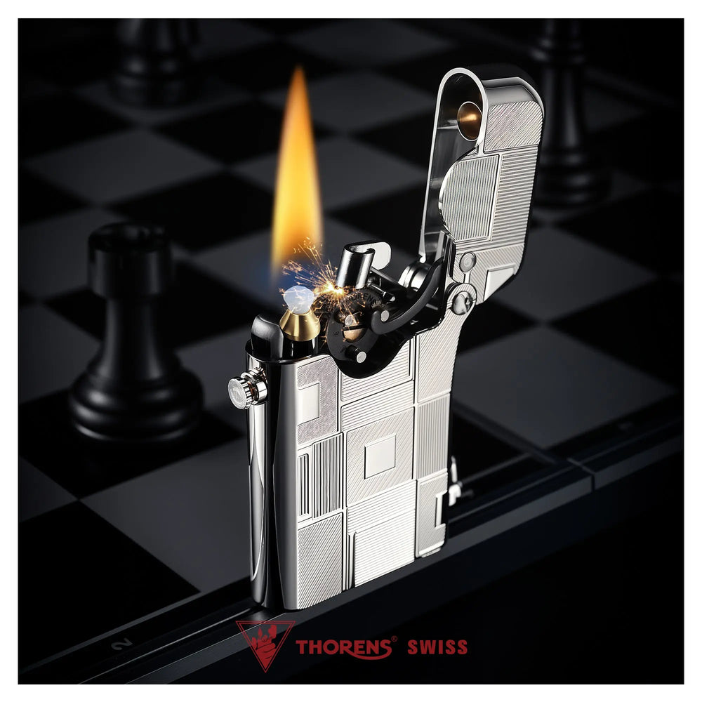 An ignited Thorens Gen 1 Single Claw lighter with silver geometric engravings, showcasing a steady flame and mechanical precision against a dark, sophisticated chessboard backdrop.