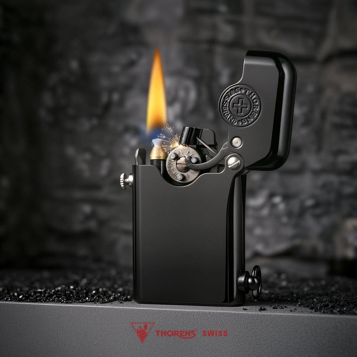 A glossy black Gen 1 Single Claw lighter ignited with a warm flame, featuring a heritage brand emblem on the inner cap and a refined mechanical ignition.