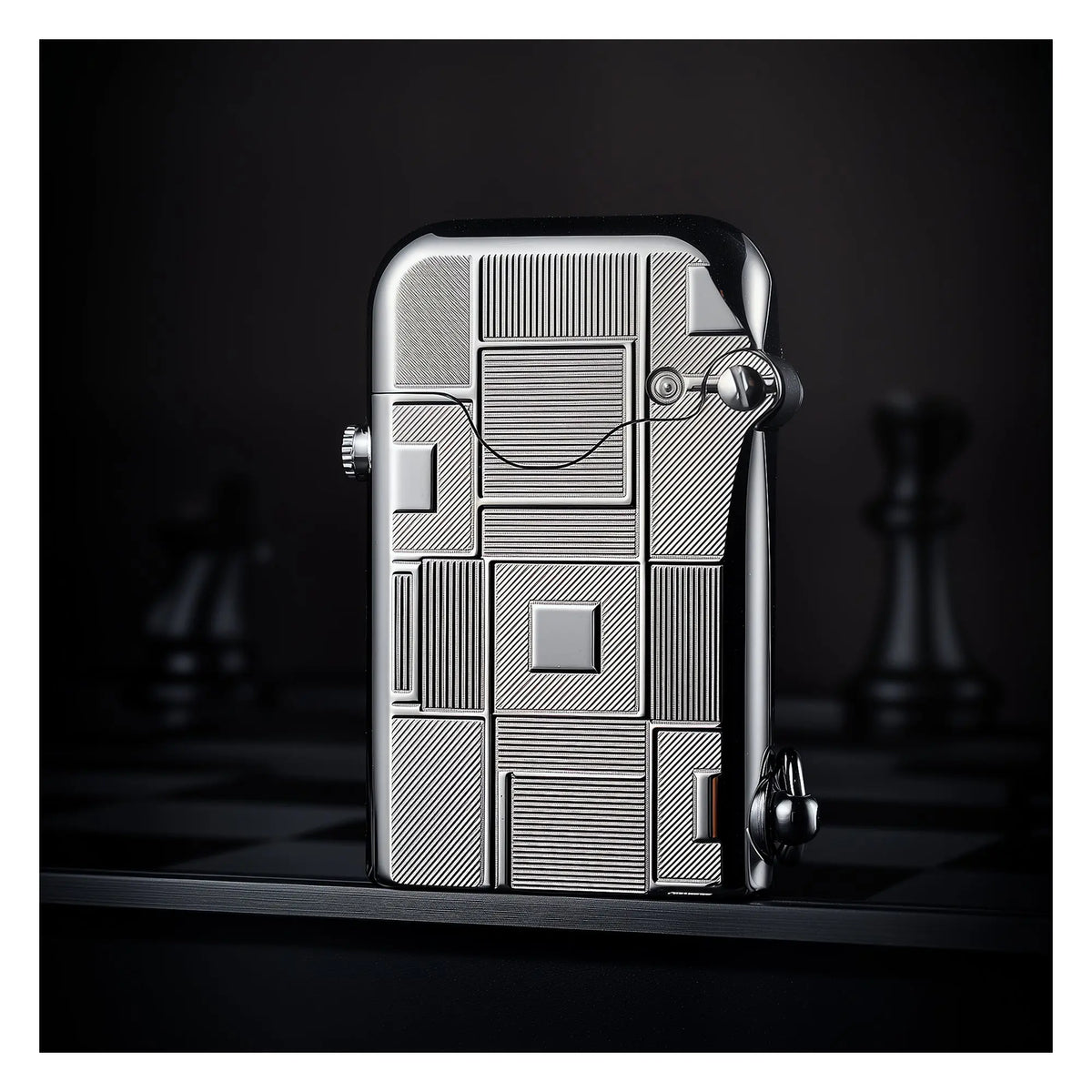 A Thorens Gen 1 Single Claw lighter with a closed lid, highlighting the intricate geometric line engravings and high-polish silver finish against a dark, atmospheric chessboard backdrop.