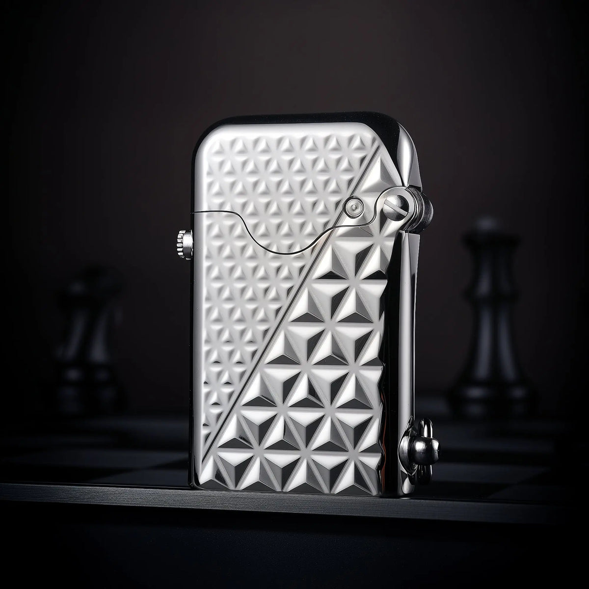 A vertical view of a silver-finished Thorens Gen 1 single claw lighter featuring a bold geometric diamond pattern engraving.