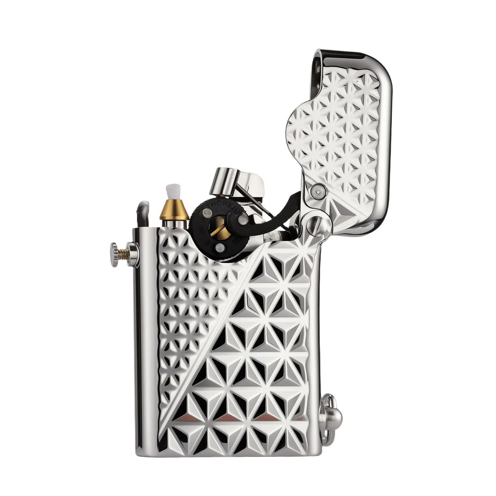 Open view of a silver Thorens Gen 1 single claw lighter, displaying the mechanical ignition wheel and geometric diamond pattern engraving.