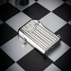 A silver Gen 1 Single Claw lighter featuring an engraved water ripple pattern and heritage brand emblem, resting on a monochrome chessboard.