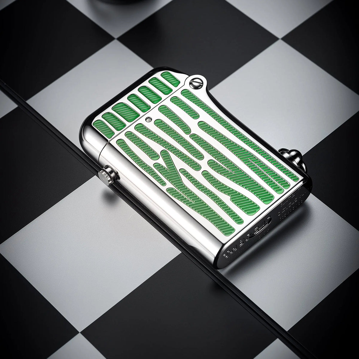 A polished silver Gen 2 Double Claw lighter with vibrant green striped inlays resting on a monochrome chessboard, highlighting its sleek profile and mechanical side-button.
