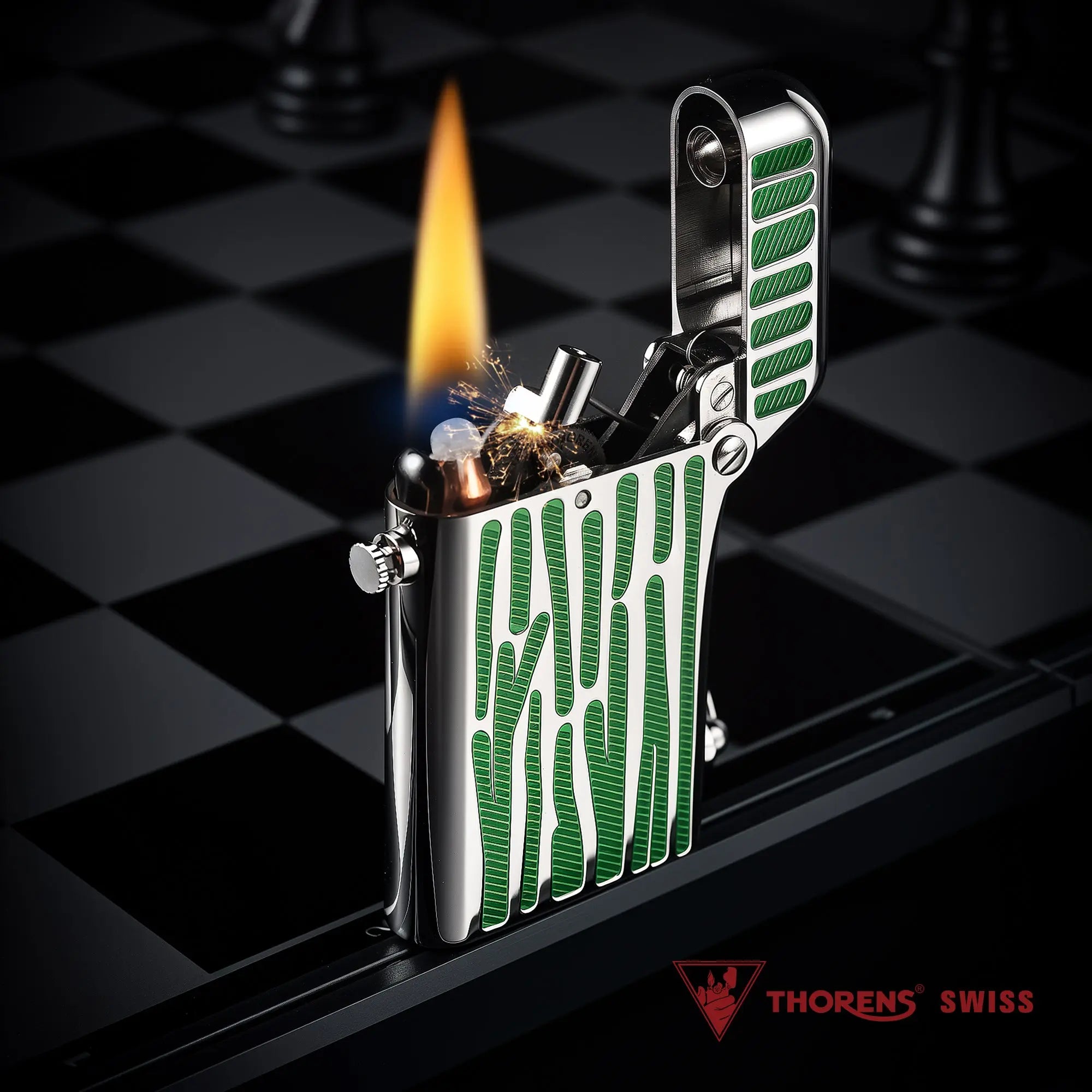 A silver Gen 2 Double Claw lighter with green striped inlays, shown ignited with a tall flame and sparks on a chessboard background.