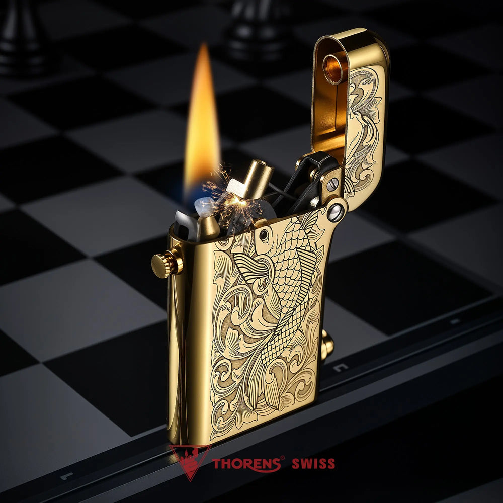 An ignited Thorens Gen 2 double claw lighter with sparks and a steady flame, featuring the iconic koi fish brass engraving.