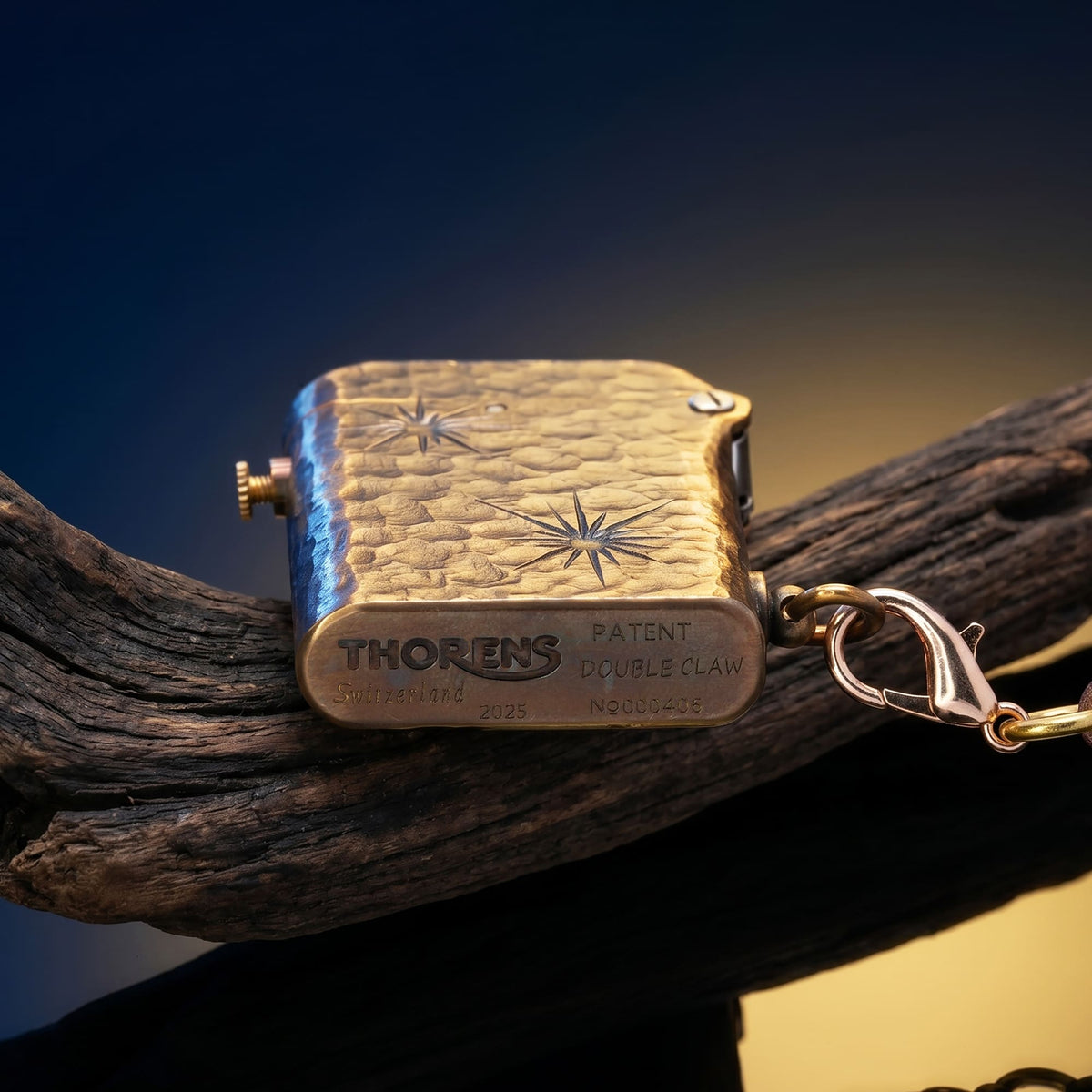 Thorens Gen 2 Double Claw Imperial Eagle lighter shown from the base, featuring engraved brand markings, patent information, star motifs, and an individual serial number.