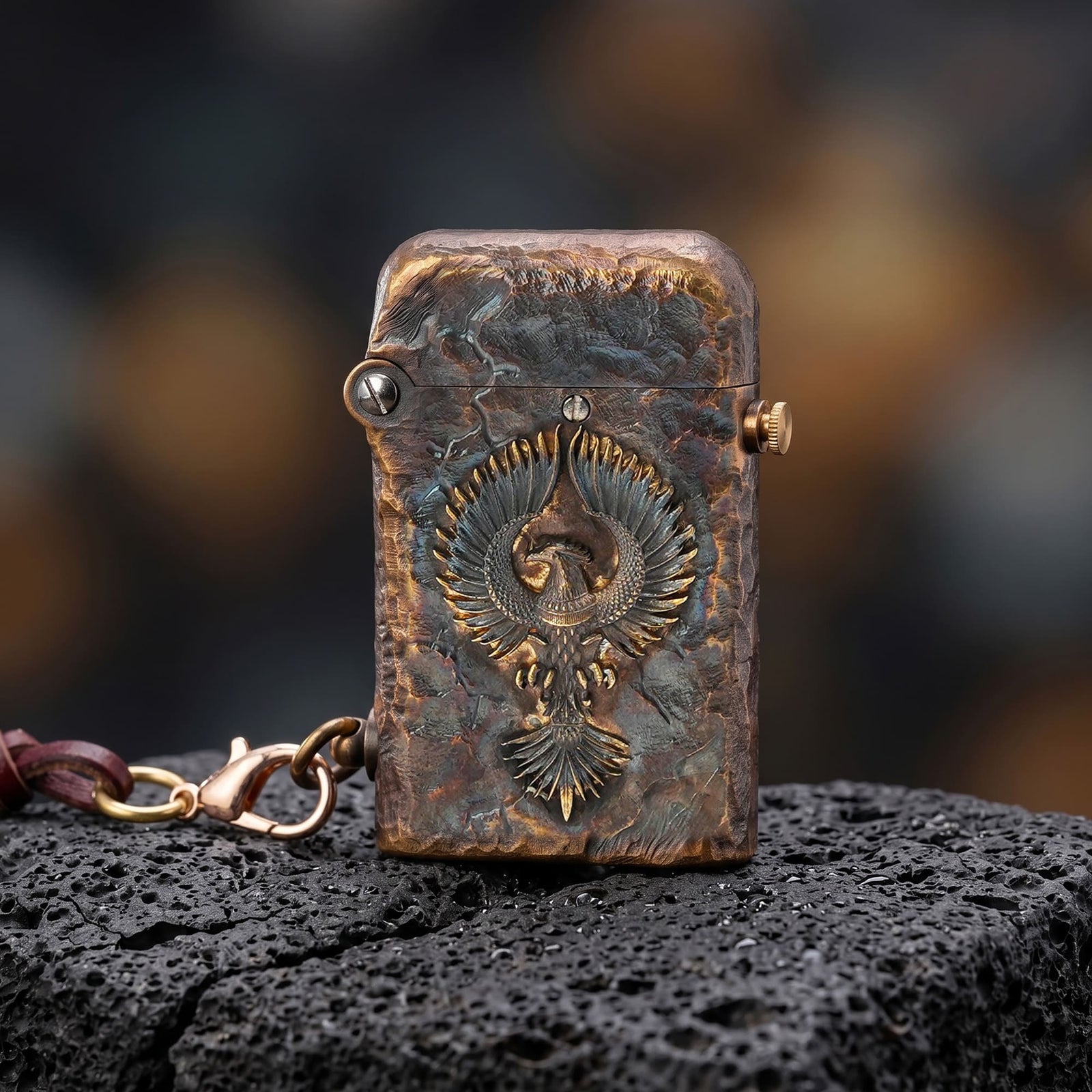 Thorens Gen 2 Double Claw Imperial Eagle lighter with lid down, showing raised eagle relief, distressed brass texture, and side chain on dark stone.