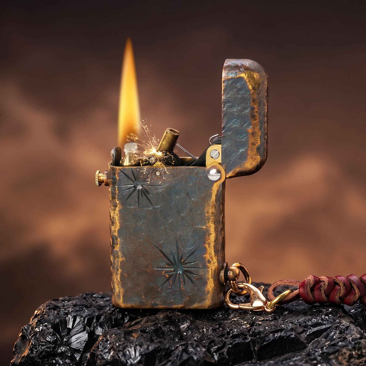 Thorens Gen 2 Double Claw Imperial Eagle lighter shown open and ignited, with distressed brass texture, visible flame, exposed mechanism, and side leather charm.