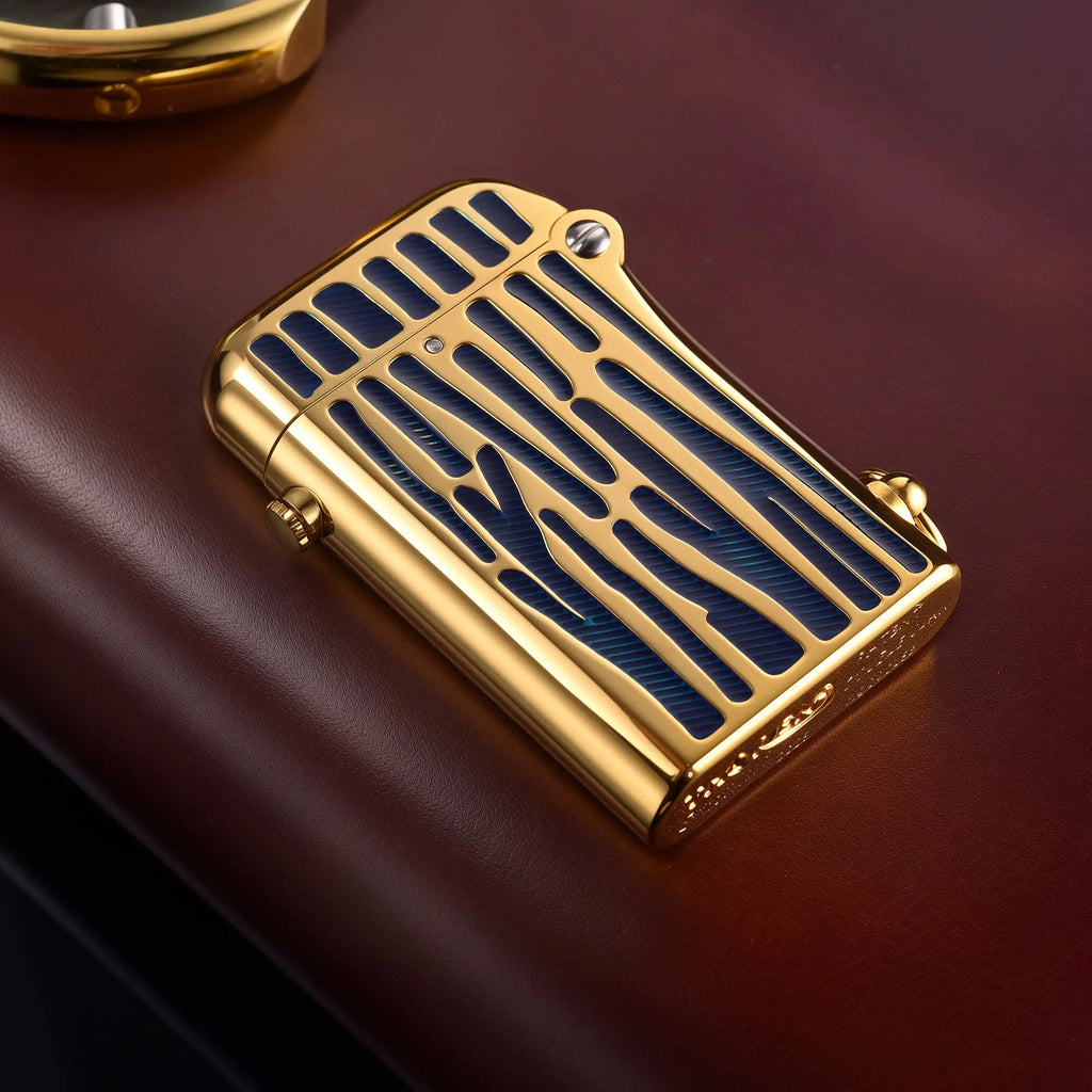 A Thorens Gen 2 Double Claw mechanical lighter featuring a polished gold chassis with striking deep blue enamel-filled vertical inlay stripes and signature automatic dual-claw ignition.