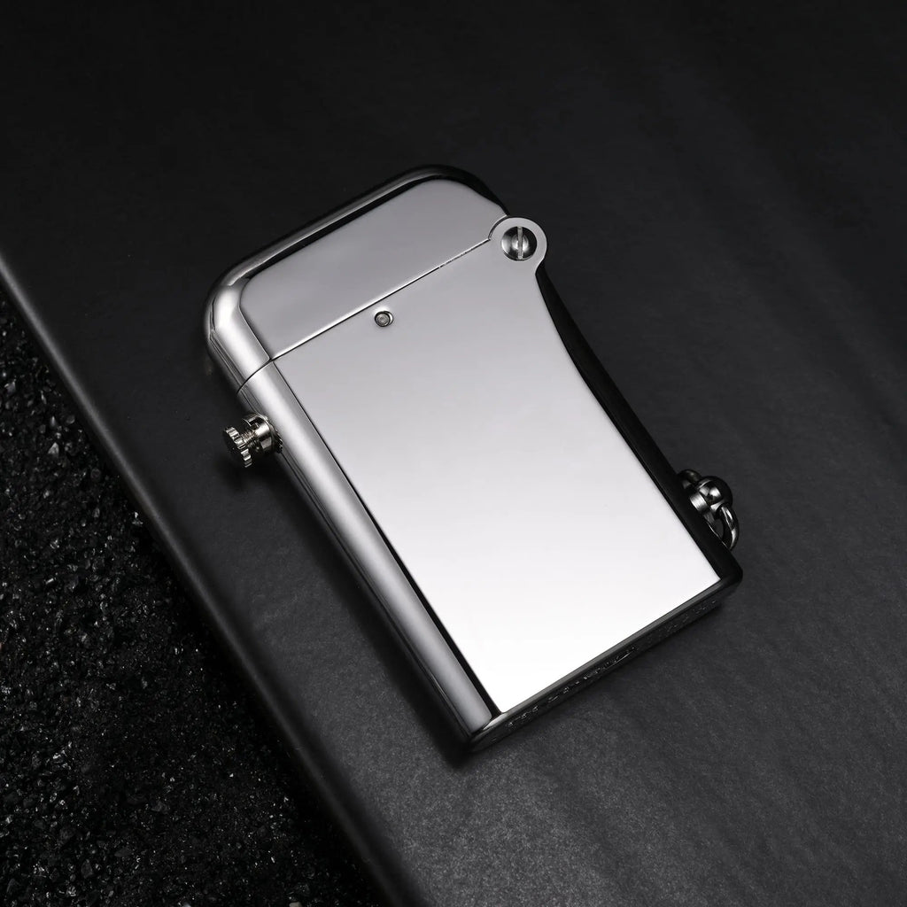 A Thorens Gen 2 Double Claw matte silver lighter resting on a dark slate surface, featuring an inset close-up of the engraved limited edition marking.