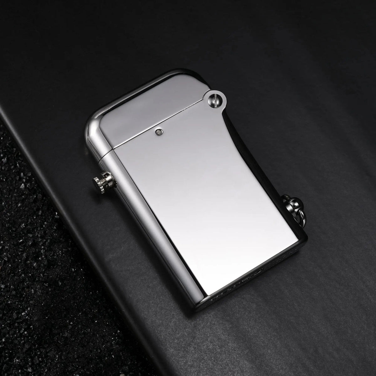 A Thorens Gen 2 Double Claw matte silver lighter resting on a dark slate surface, featuring an inset close-up of the engraved limited edition marking.