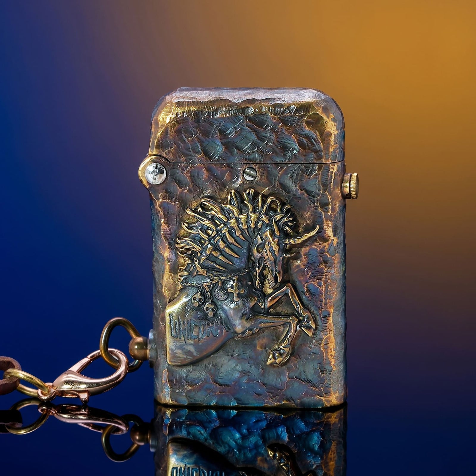 Thorens Gen 2 Double Claw Warhorse lighter shown closed with raised horse relief, distressed blue-brown brass finish, and side chain.