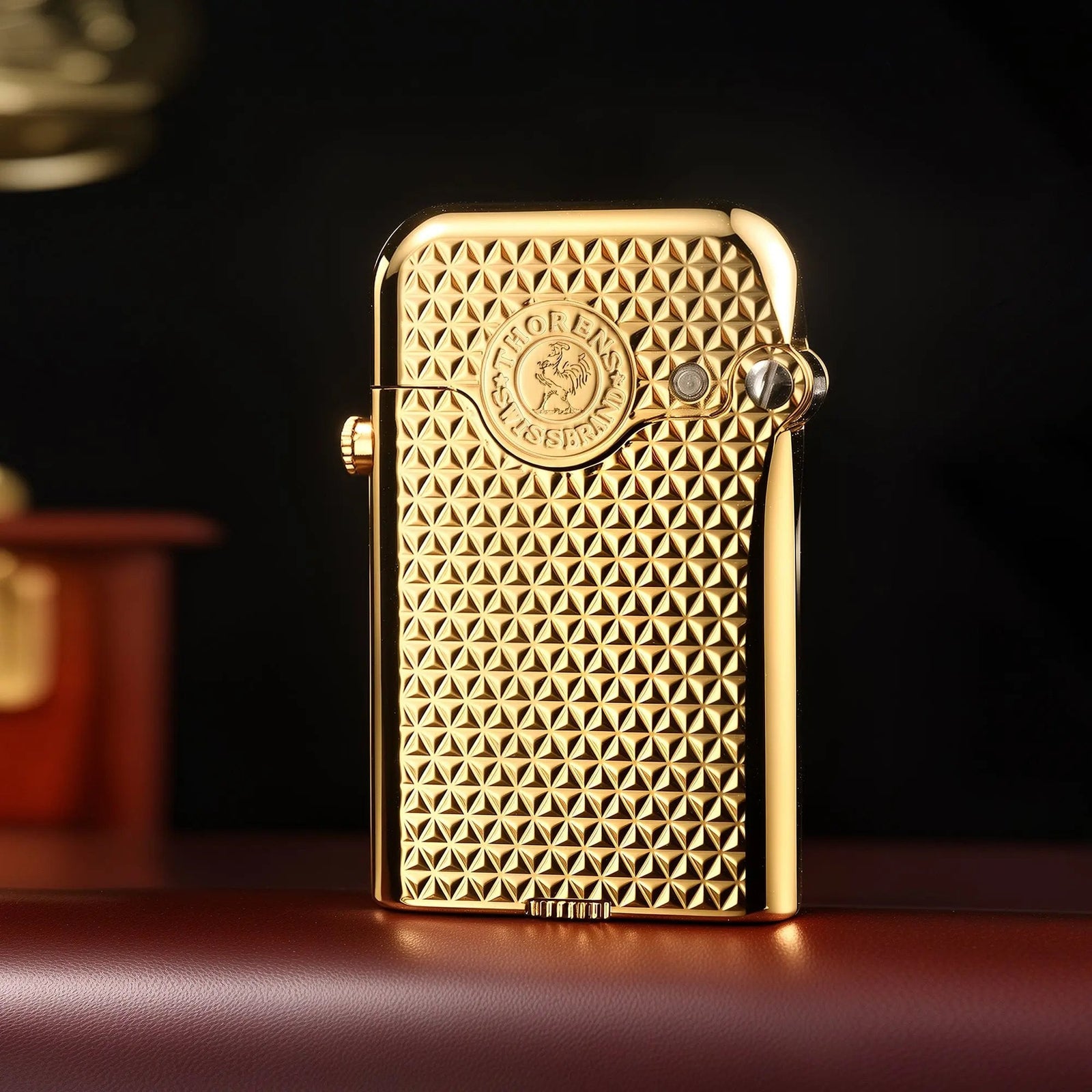 A closed Thorens Gen 3 mechanical lighter in polished gold, showcasing a precise diamond grid pattern and the iconic heritage emblem.