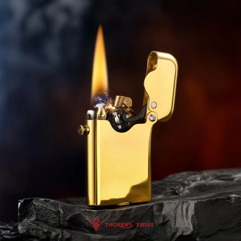 A Thorens Gen 3 Single Claw glossy brass finish lighter ignited with a tall flame and visible sparks, showcasing the precise mechanical claw mechanism against a dark, textured background.