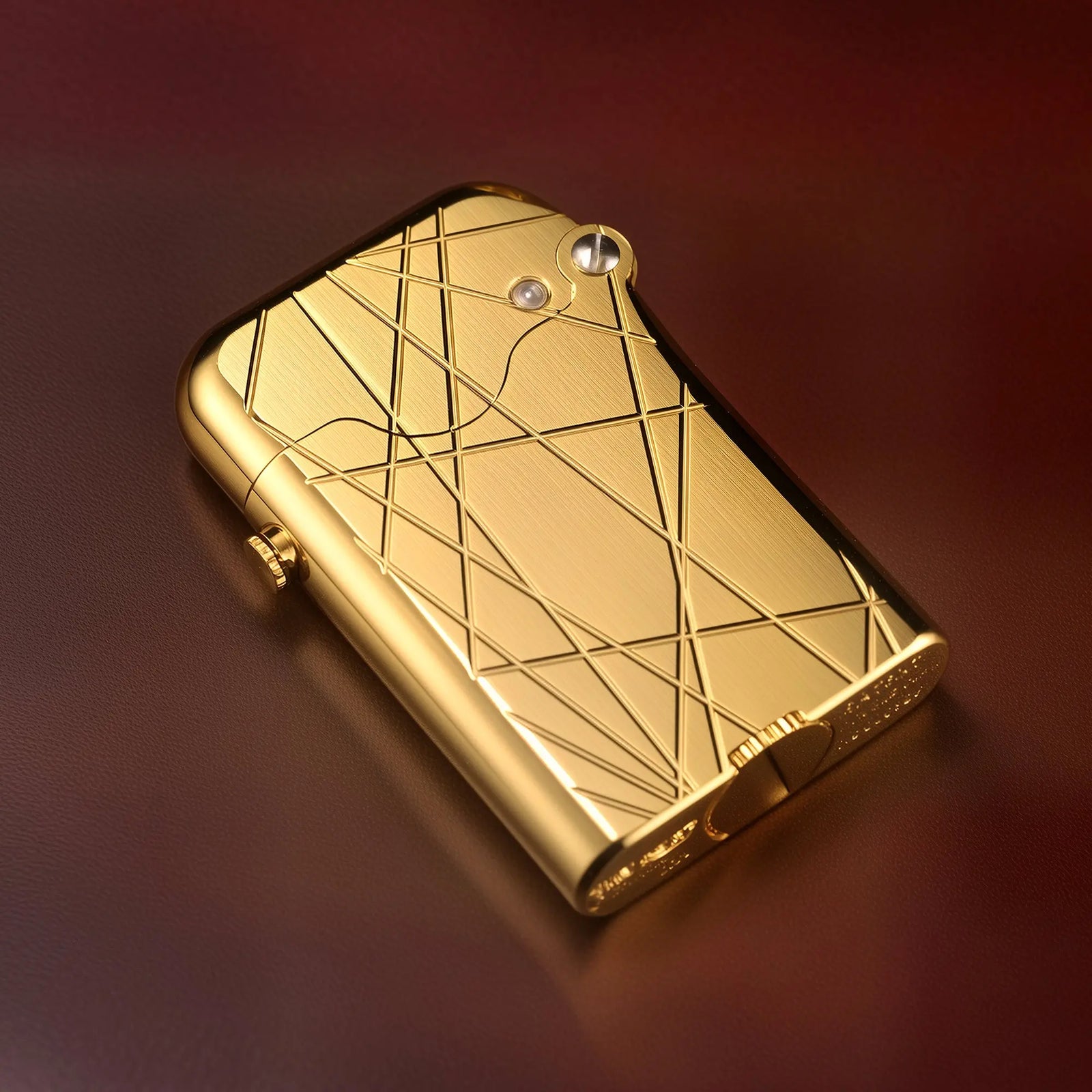 A Thorens Gen 3 Single Claw lighter in a gold finish, featuring a modern grid pattern of intersecting lines engraved across its mechanical brass body.