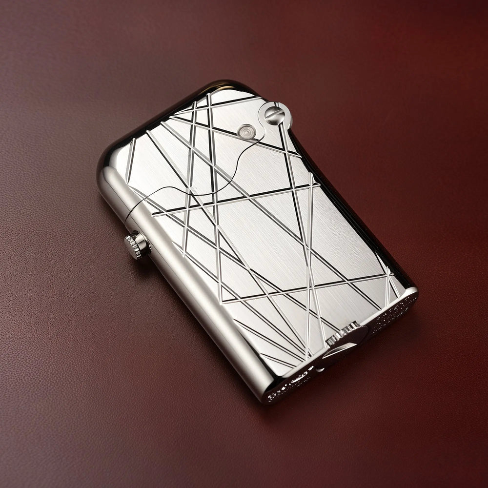 An angled shot of the Thorens Gen 3 Single Claw lighter in a silver finish, featuring a brushed texture and an engraved modern grid of intersecting lines.