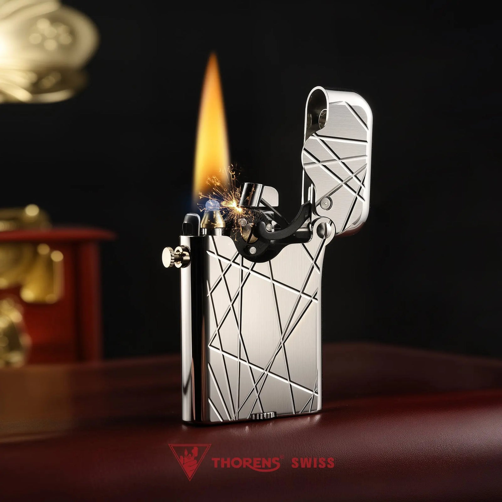 A Thorens Gen 3 Single Claw lighter in a silver finish with a modern grid pattern, shown at the moment of ignition with sparks and a steady flame in a sophisticated setting.