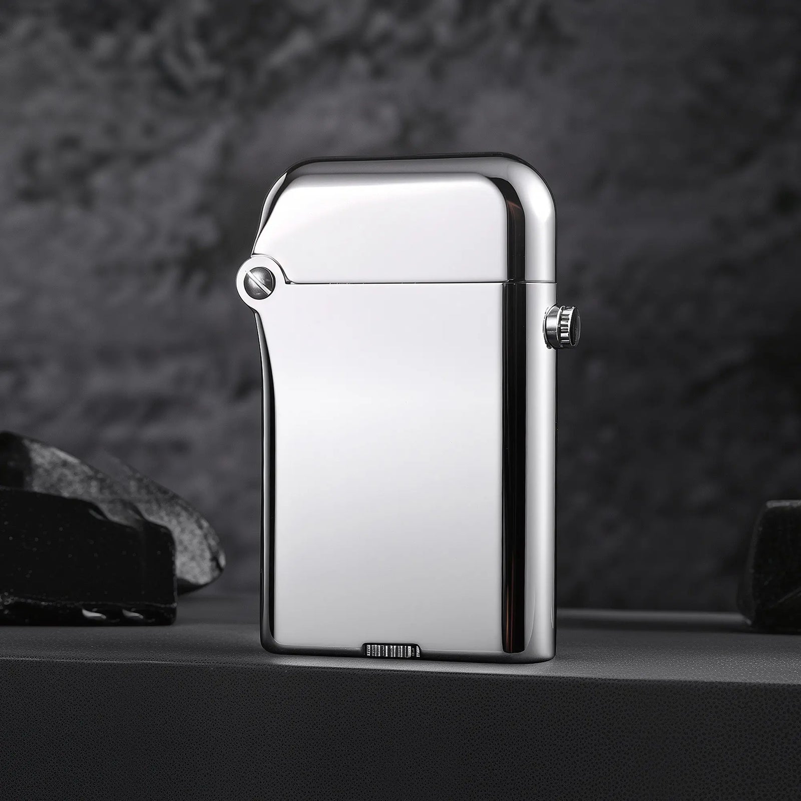 A Thorens Gen 3 Single Claw lighter featuring a polished silver glossy finish and heritage mechanical structure against a dark, textured background.