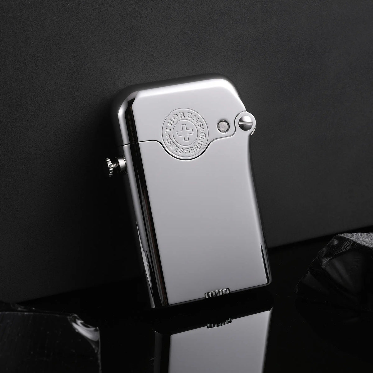 A glossy silver Gen 3 Single Claw lighter with an embossed brand emblem, resting on a reflective surface against a minimalist dark background.