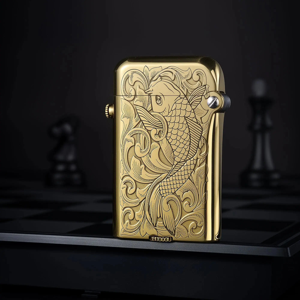 Polished brass Thorens Gen 4 double claw lighter featuring an intricate koi fish and floral pattern engraving.