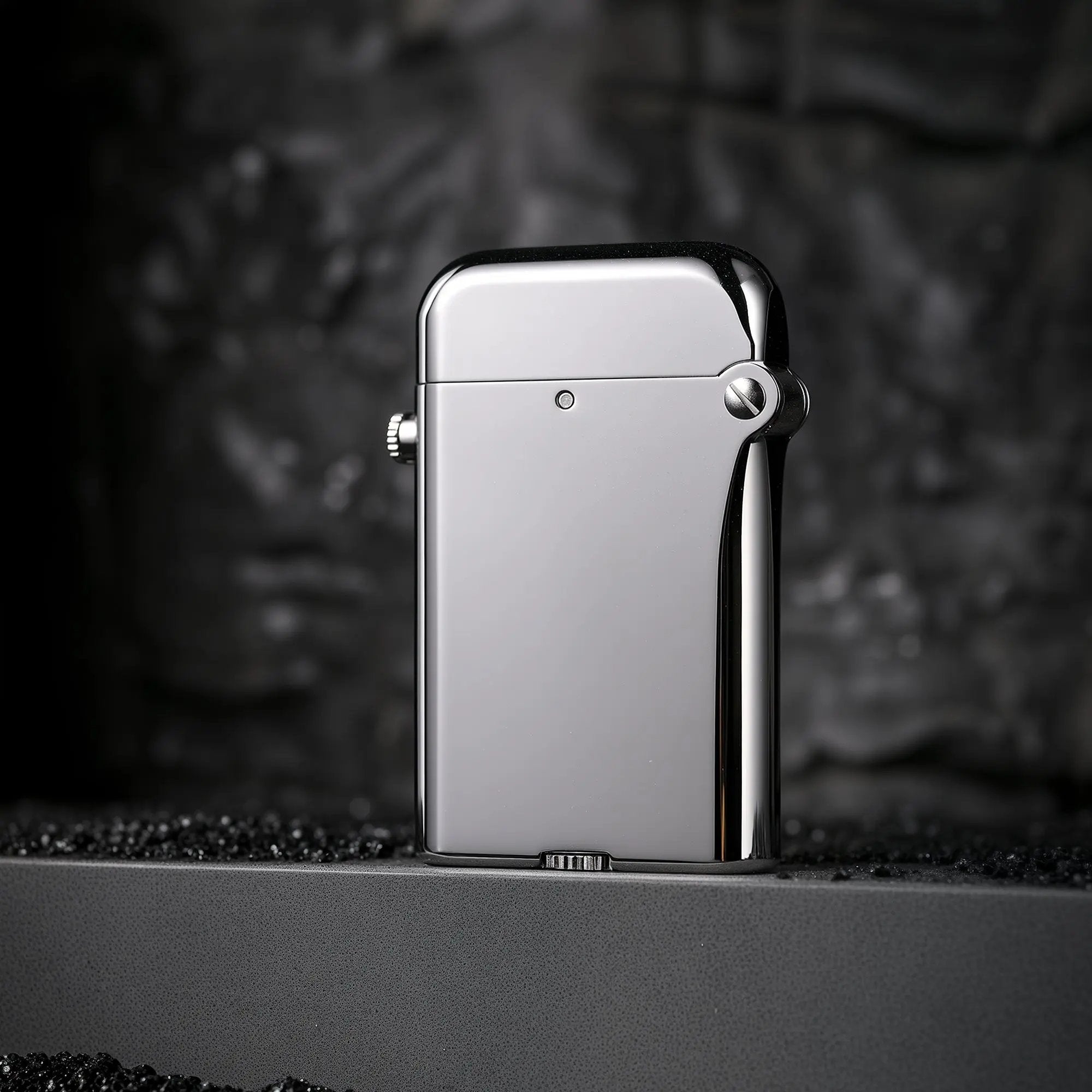 A polished silver Thorens Gen 4 double claw lighter featuring a high-gloss mechanical body and bottom-fill screw design on a textured surface.