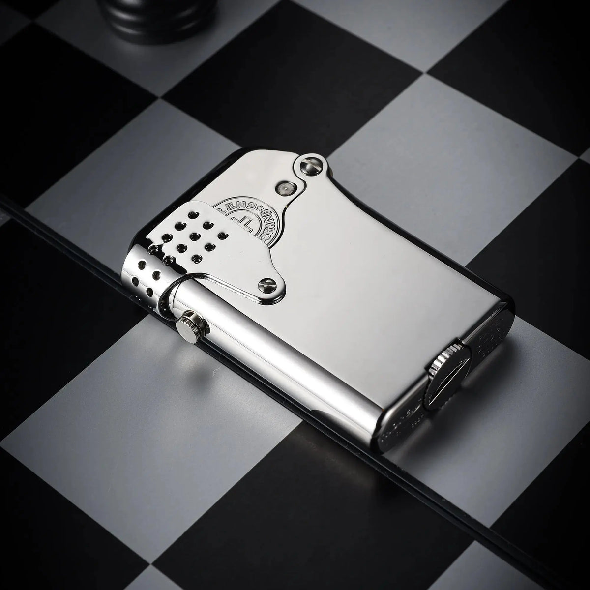 A Thorens Gen 5 Single Claw STORM silver lighter in a polished mirror finish, showcasing the windproof guard and precision mechanical lever on a chessboard.