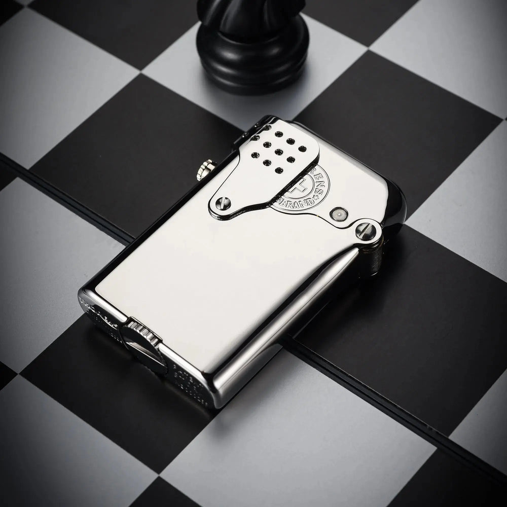 A polished silver Thorens Gen 5 Single Claw STORM lighter featuring a classic windproof guard and mechanical precision, resting on a checkered chessboard.
