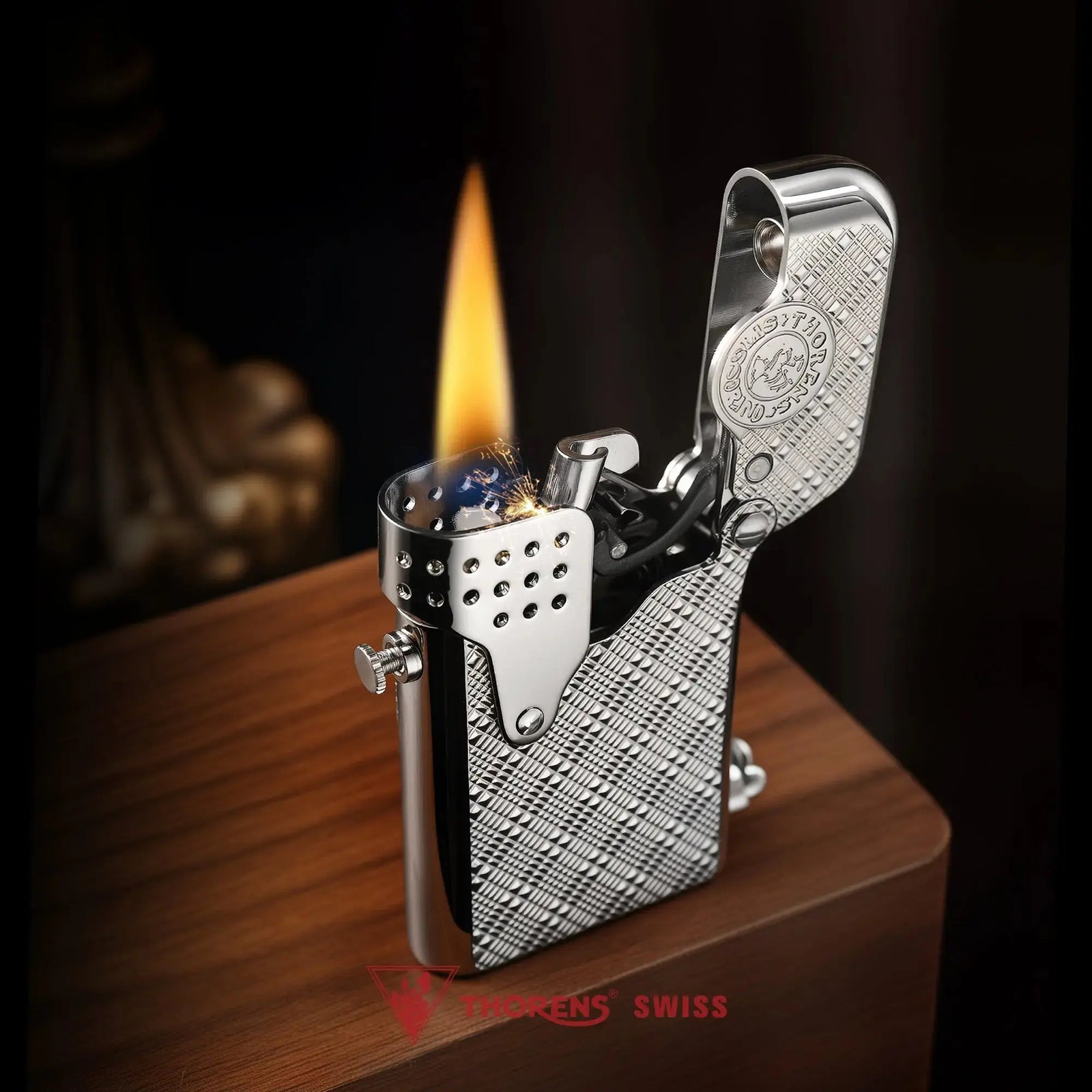 An angled lifestyle shot of the silver Thorens Gen 5 Single Claw "STORM" lighter, featuring a Starry Mesh pattern, active ignition sparks, and a tall flame against a wooden and dark-toned background.