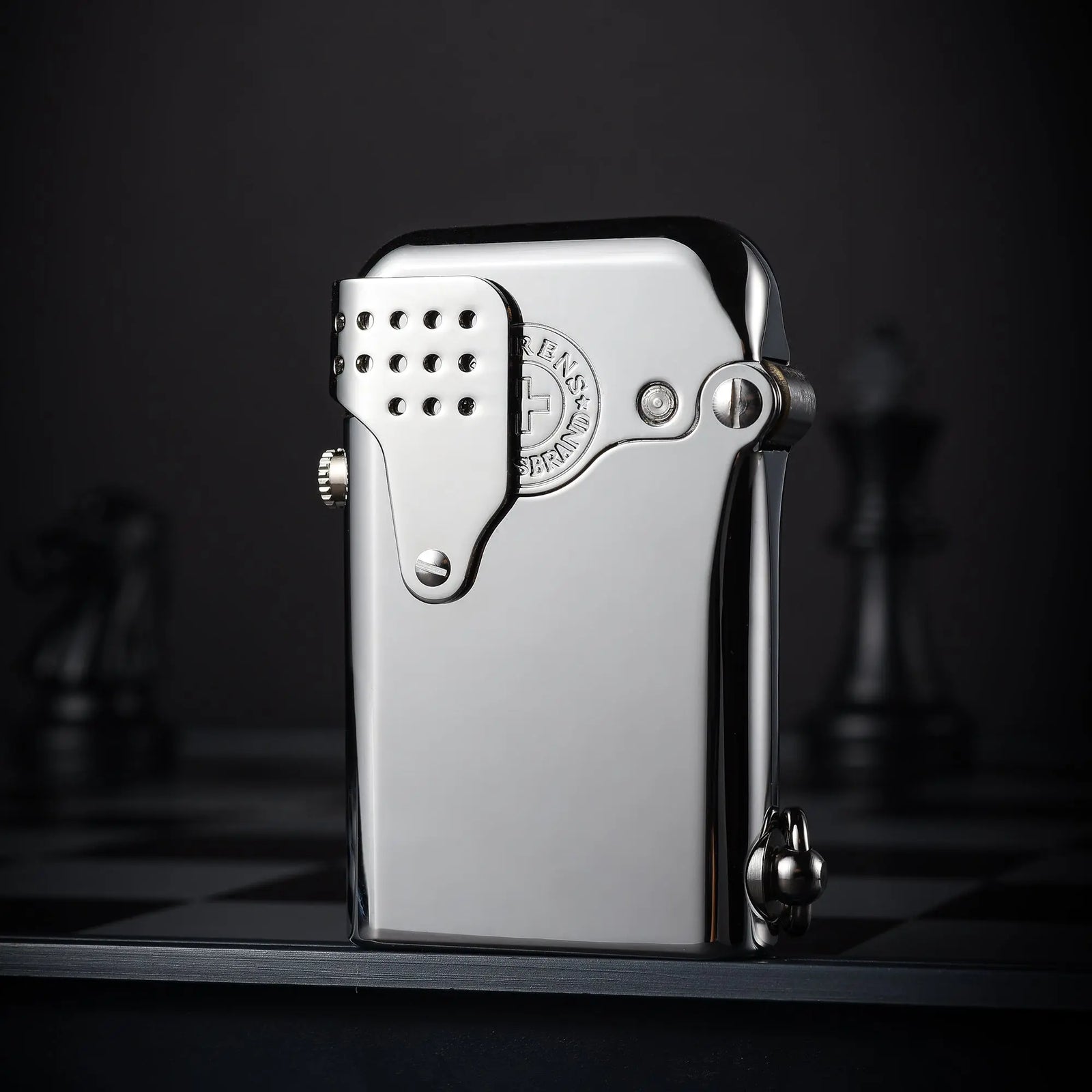 A polished silver Gen 5 Single Claw Storm lighter in a closed position, highlighting the perforated wind-guard and mechanical side-fill screw.