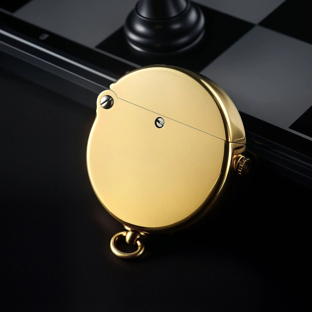 A vertical view of the circular Thorens Gen 8 Double Claw lighter in glossy brass, featuring a smooth metallic finish and heritage lanyard ring against a dark background.