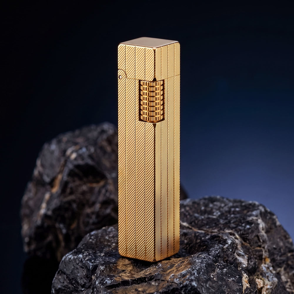 Thorens rectangular lighter with gold diagonal pattern shown with the lid down, highlighting the slim body shape, surface pattern, and side ignition wheel.