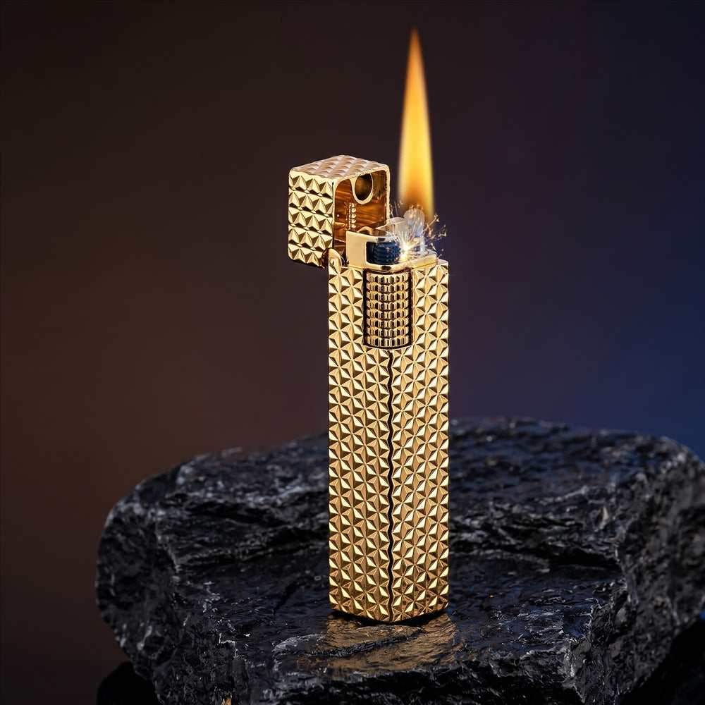 Thorens rectangular lighter with gold starburst pattern shown open and ignited, highlighting the bright flame, spark, side ignition wheel, and raised surface pattern.