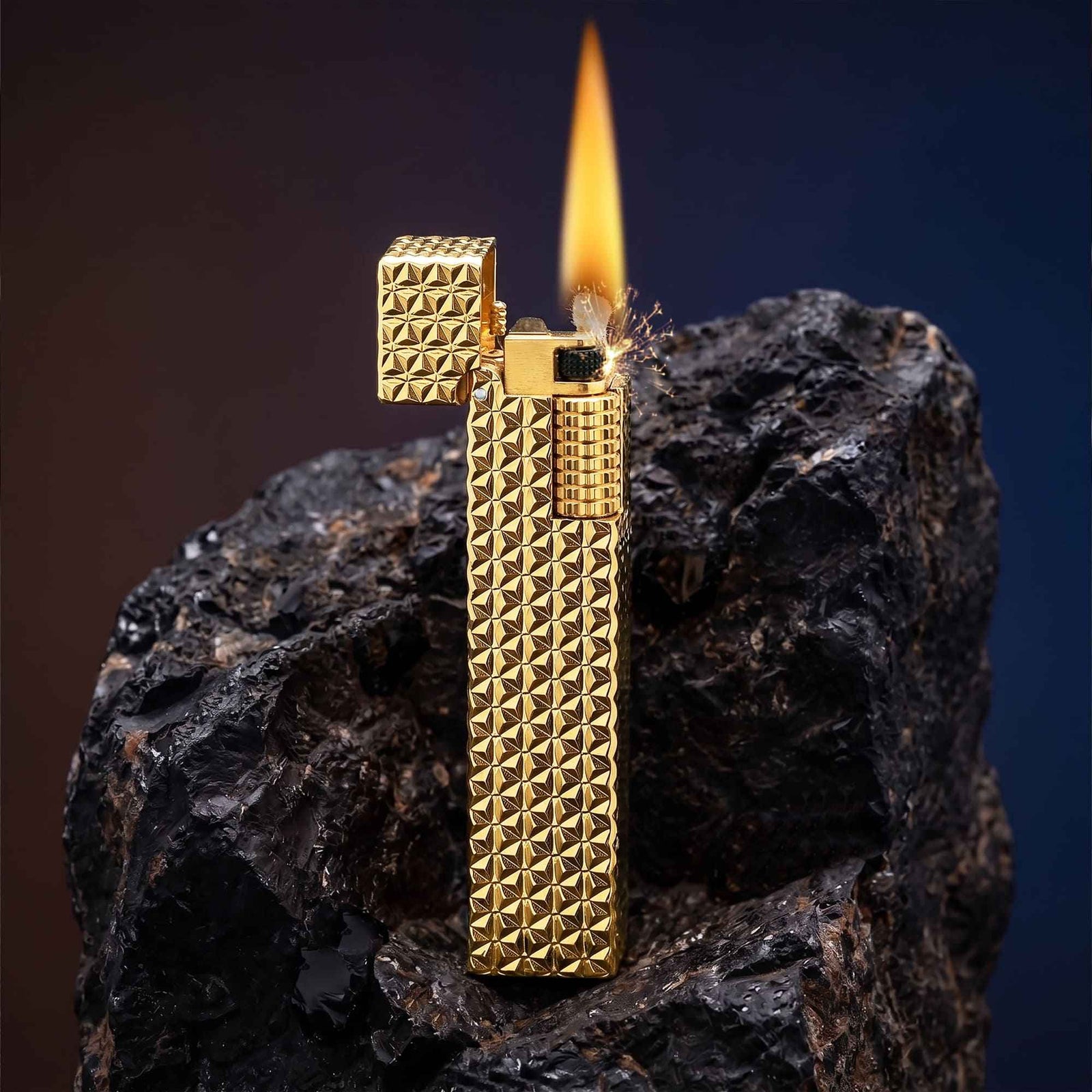 Thorens rectangular lighter with gold starburst pattern shown open and ignited, highlighting spark, flame, side ignition wheel, and engraved brass texture.