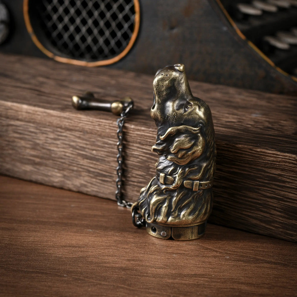 A vertical perspective of the Thorens Golden Retriever lighter, showing the antique brass dog head sculpture with detailed fur and collar, resting on wood.