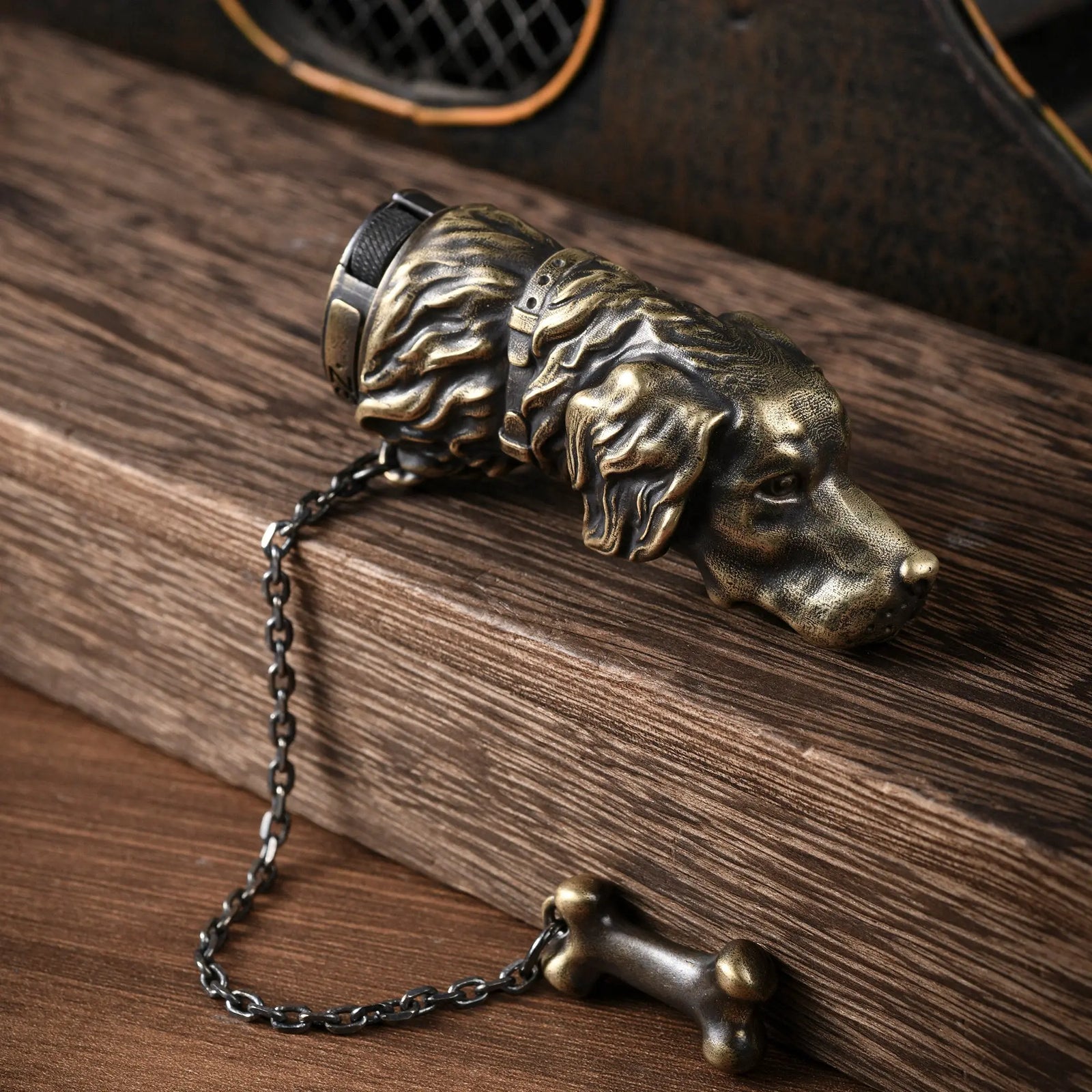 A detailed view of the Thorens Golden Retriever lighter in antique brass, showcasing the textured fur craftsmanship, collar detail, and attached bone charm.